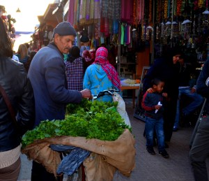 A man leads his bike through the crowded market in the old Medina.